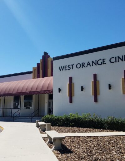 Exterior view of west orange cinema with decorative facade and awning.