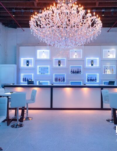 Modern bar setup for an event with elegant lighting and blue accents.