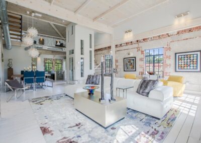 Bright, modern living space with exposed brick walls and eclectic furnishings.